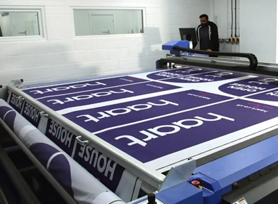 banner fabric being processed on a DYSS digital cutter